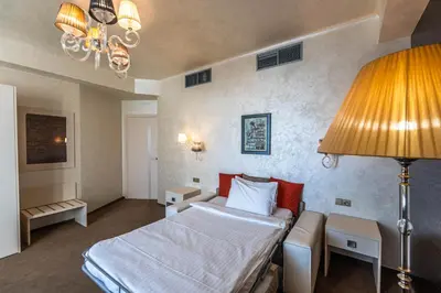 a hotel room with a bed and a lamp at Residence Mysterius Old Town in Prague