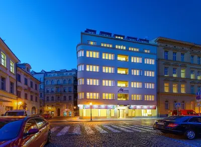 a tall building with cars parked in front of it at Residence Mysterius Old Town in Prague