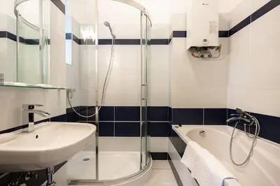 a bathroom with a sink and a shower and a tub at Hubert Family Rezidence Prague in Prague