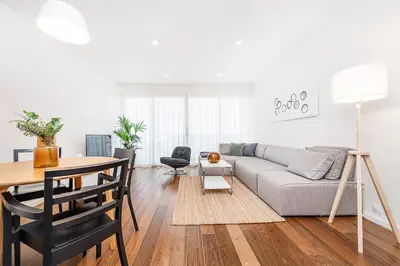 a living room with a couch and a table at Stunning Modern 2bedroom with Iconic View in Prague