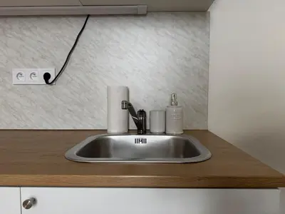 a kitchen sink with a faucet on a counter at Alabaster - Prague Apartment in Prague