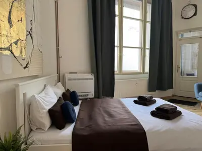 a bedroom with a bed with towels on it at Alabaster - Prague Apartment in Prague