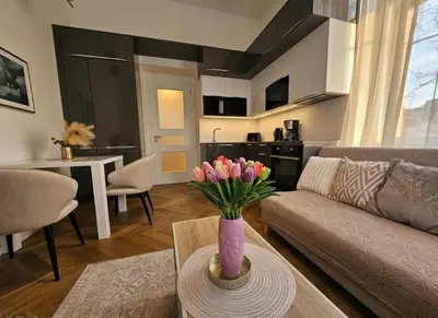 a living room with a couch and a table with flowers at Beautiful apartment with terrace in center of Prague in Prague