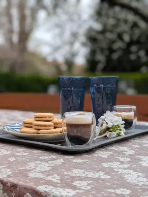 a tray with cookies and cups on a table at Secret Garden Studio in Prague