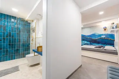 a bathroom with a toilet and a bed at Secret Garden Studio in Prague