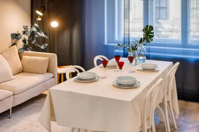a white table with plates and wine glasses on it at 100m2, 3 room, Old Town Prague Flat in Golčŭv Jeníkov