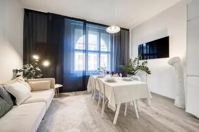 a living room with a table and a couch at 100m2, 3 room, Old Town Prague Flat in Golčŭv Jeníkov
