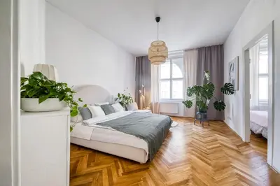 a white bedroom with a large bed and potted plants at 100m2, 3 room, Old Town Prague Flat in Golčŭv Jeníkov