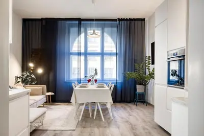 a kitchen and living room with a table and a window at 100m2, 3 room, Old Town Prague Flat in Golčŭv Jeníkov