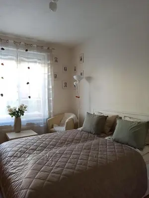 a bedroom with a large bed and a window at Spacious apartment with garden and private parking in Prague