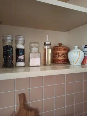 a shelf in a kitchen with jars and vases at Spacious apartment with garden and private parking in Prague