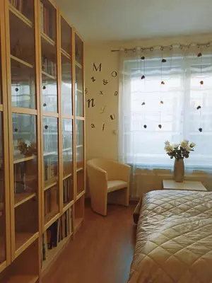 a bedroom with a bed and a window with birds on the wall at Spacious apartment with garden and private parking in Prague