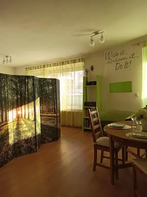 a living room with a table and a dining room at Spacious apartment with garden and private parking in Prague