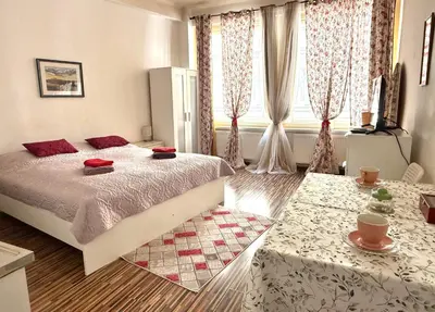a bedroom with a large bed and two tables at Prague Old Town Apartment Benediktska 6 in Prague