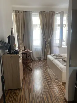 a bedroom with a bed and a television in a room at Prague Old Town Apartment Benediktska 6 in Prague