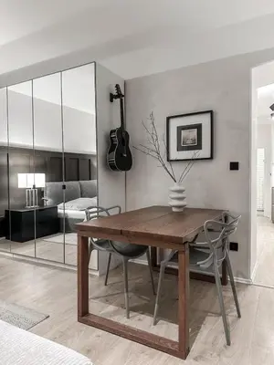 a dining room with a table and a guitar on the wall at Design apartment in Prague 6 in Prague