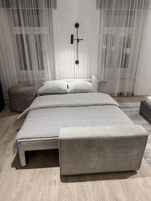 a bedroom with two beds and a cross on the wall at Design apartment in Prague 6 in Prague