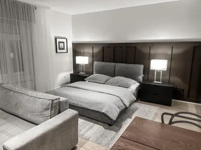 a bedroom with a bed and a couch at Design apartment in Prague 6 in Prague