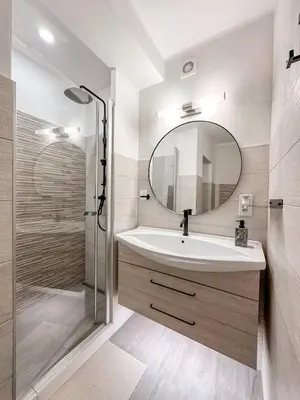 a bathroom with a sink and a mirror at Design apartment in Prague 6 in Prague