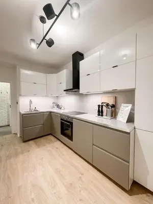 a kitchen with white cabinets and a counter top at Design apartment in Prague 6 in Prague