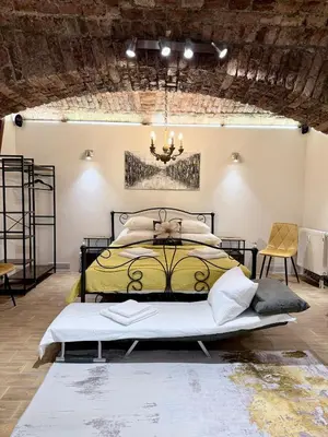 a bedroom with a bed and a chandelier at Apartment MozArt Prague in Prague