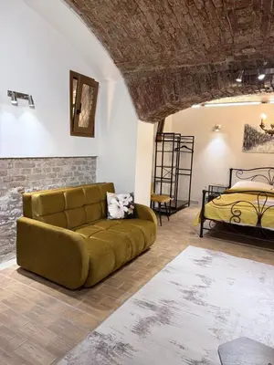 a living room with a couch and a bed at Apartment MozArt Prague in Prague