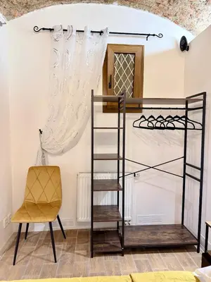 a room with a bunk bed and a chair at Apartment MozArt Prague in Prague