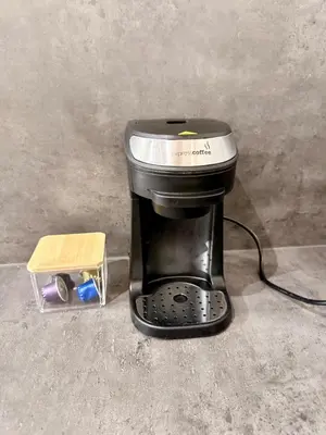 a coffee maker sitting on the floor next to a toy at Apartment MozArt Prague in Prague