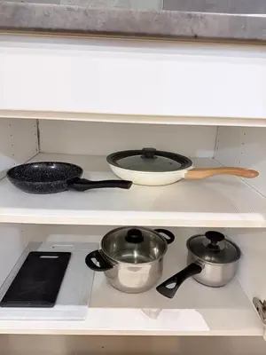 a shelf with two pots and pans on a stove at Apartment MozArt Prague in Prague