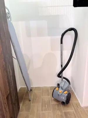 a vacuum cleaner on the floor next to a wall at Apartment MozArt Prague in Prague