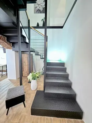 a staircase in a house with a black stair case at Apartment MozArt Prague in Prague