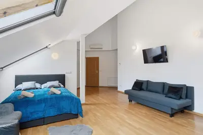 a bedroom with a bed and a couch and a tv at Nature Diamond Suite in Prague
