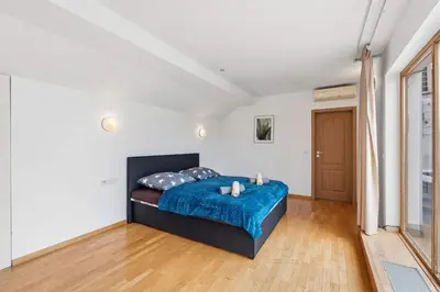 a bedroom with a bed with a blue blanket at Nature Diamond Suite in Prague