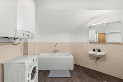 a bathroom with a tub and a sink and a bath tubermott at Nature Diamond Suite in Prague