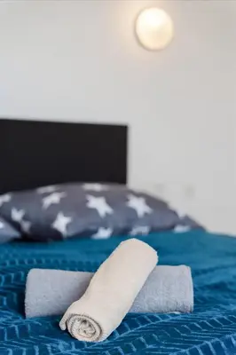 a rolled up towel on top of a bed at Nature Diamond Suite in Prague