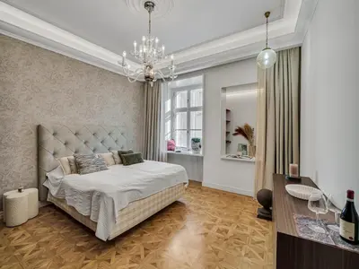 a bedroom with a bed and a chandelier at Romantic Apartman by Prague Castle in Prague