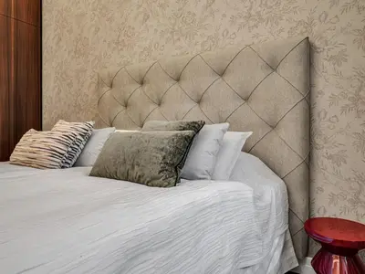 a bed with a large headboard and pillows on it at Romantic Apartman by Prague Castle in Prague
