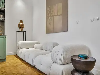 a living room with a white couch and a table at Romantic Apartman by Prague Castle in Prague