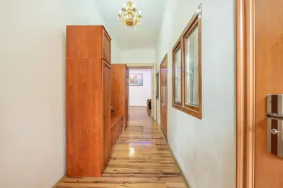 a hallway with a wooden floor and a chandelier at 3BR Apartment in Old Town - Self Check-in - Prague 1 - Sleep up to 8 in Prague