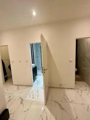 a large room with a mirror and white walls at Florenc Grant Apartments in Prague