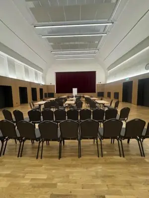 a large room with chairs and tables in it at Ubytování TJ Sokol Kostelec nad Černými lesy in Kostelec nad Černými Lesy