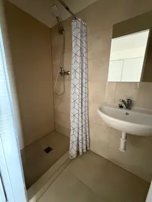 a bathroom with a sink and a shower at Ubytování TJ Sokol Kostelec nad Černými lesy in Kostelec nad Černými Lesy