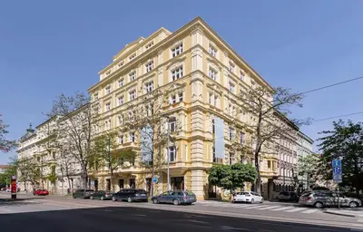a large building with cars parked in front of it at Vinohrady 105 - Prestige in Prague