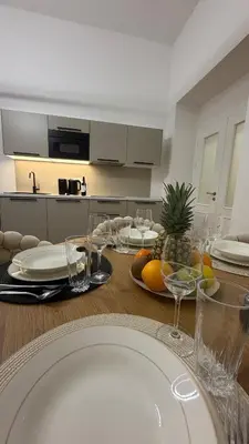 a dining room table with wine glasses and fruit on it at Vinohrady 105 - Prestige in Prague