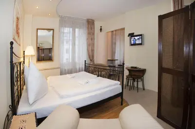a hotel room with a bed and a table at Just For Two Ruterra Studio in Prague
