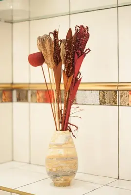 a vase filled with flowers sitting on a counter at Just For Two Ruterra Studio in Prague