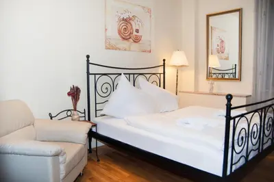 a bedroom with a bed and a chair at Just For Two Ruterra Studio in Prague