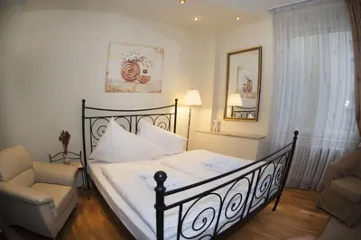 a bedroom with a bed and a chair at Just For Two Ruterra Studio in Prague