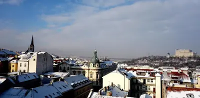 a view of a city with snow covered roofs at Apartment Lupáčova in Prague