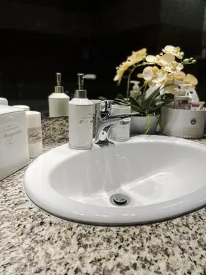 a bathroom sink with two soap dispensers on it at Apartment Lupáčova in Prague